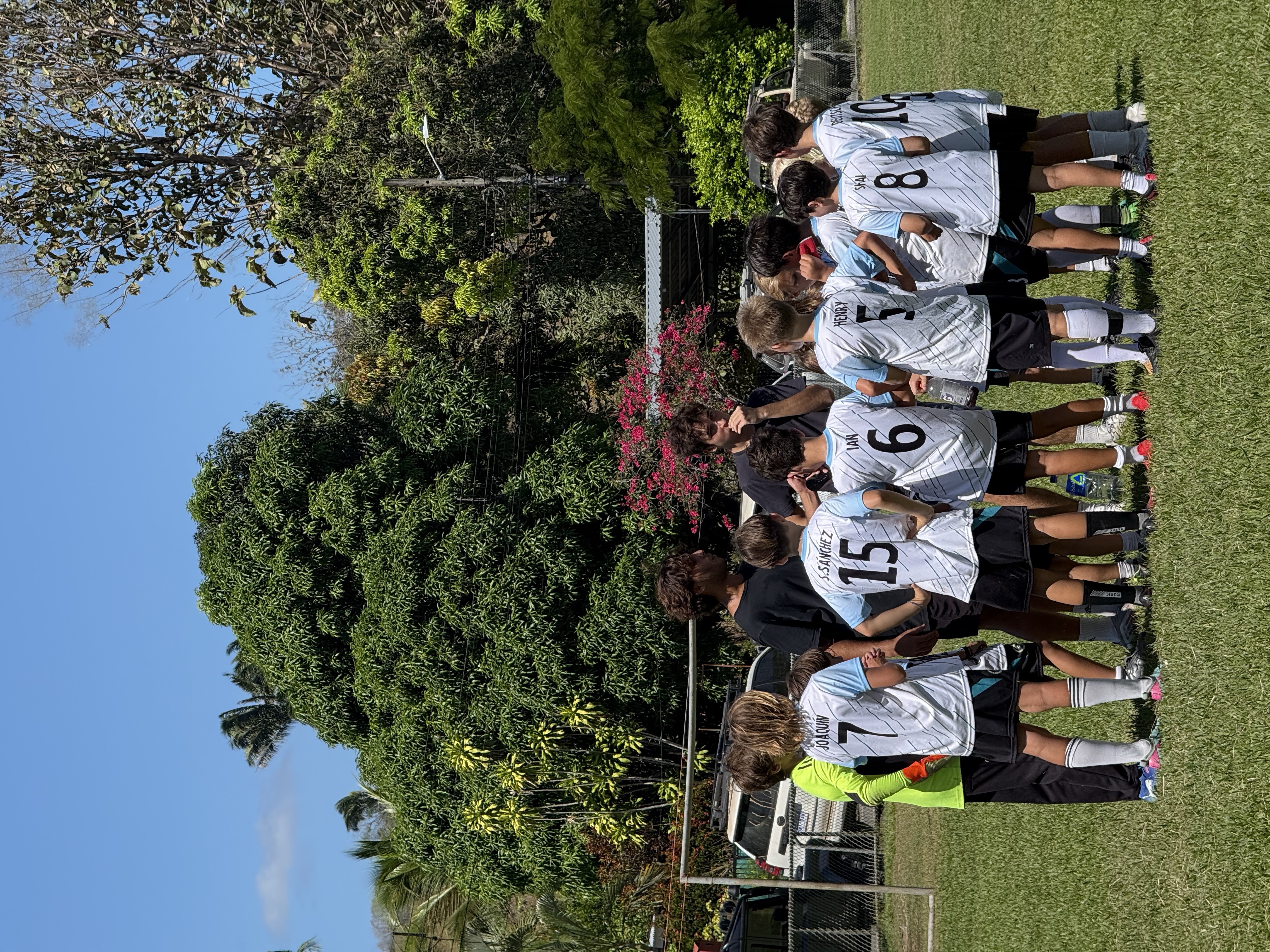 NAC players standing together with their coaches